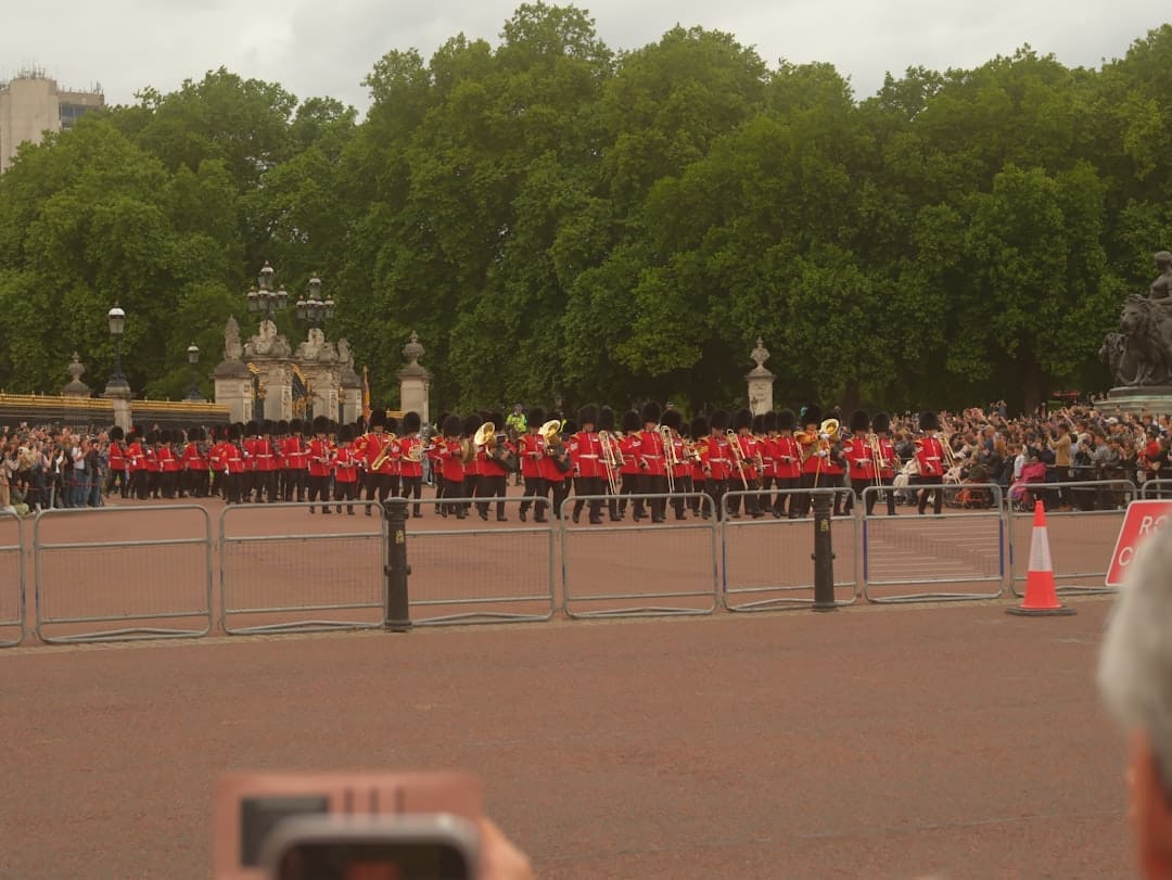 veteran suicide prevention — Guards in red uniforms marching with brass instruments.